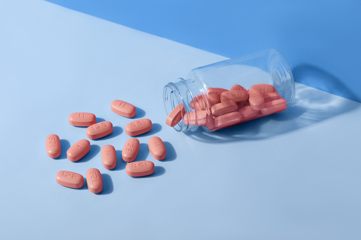 HIV therapy pills on blue background