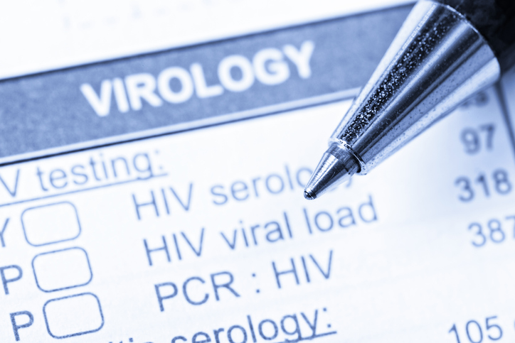 On a medical record form, a pen rests on the section where Virology blood tests to be ordered are recorded. These blood tests relate to HIV and AIDS.