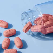 HIV therapy pills on blue background